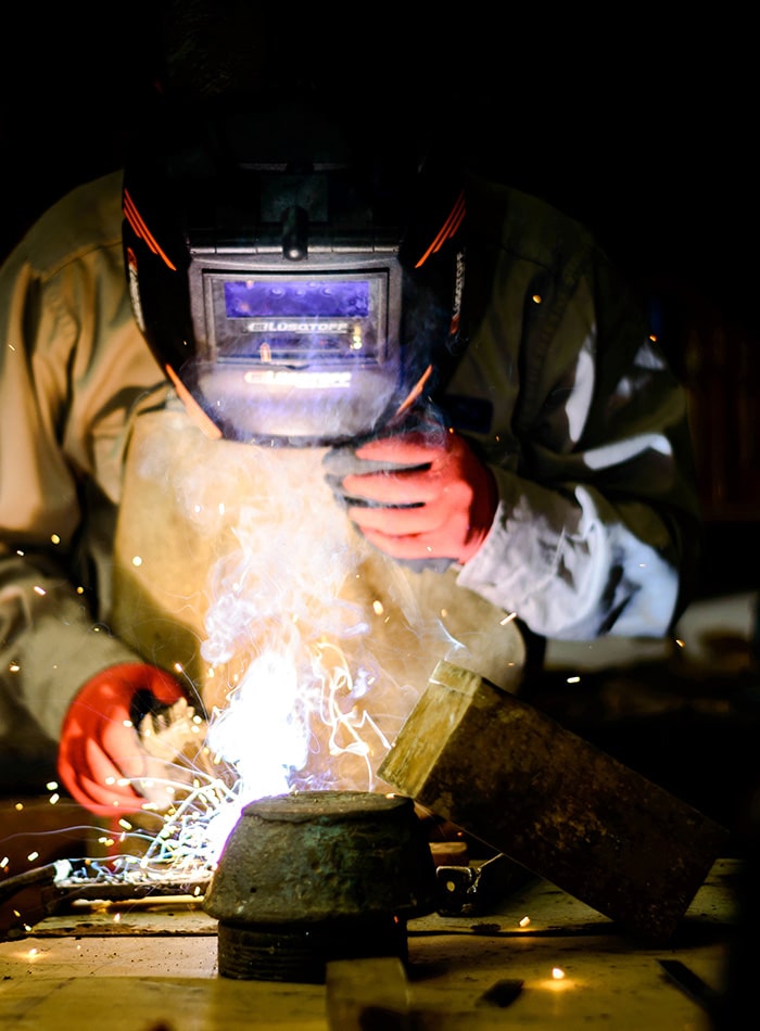 person wearing a helmet and welding